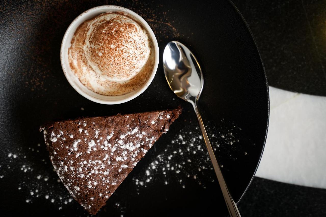 Ambiance Boutique Art Hotel Lahore Exteriör bild A chocolate cake with a cup of coffee